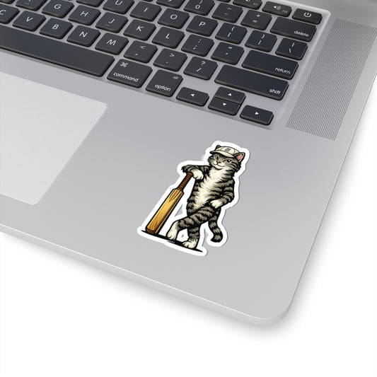 Laptop with a sticker of a cat holding a baseball bat on a white surface