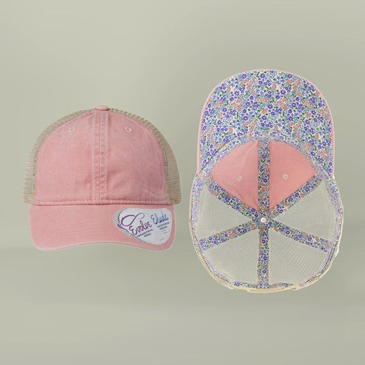 Pink baseball cap with floral mesh back on a light green background